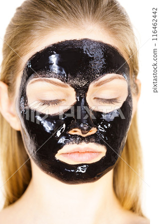 Woman with black peel off mask on face Woman with black peel off mask on face 116462442