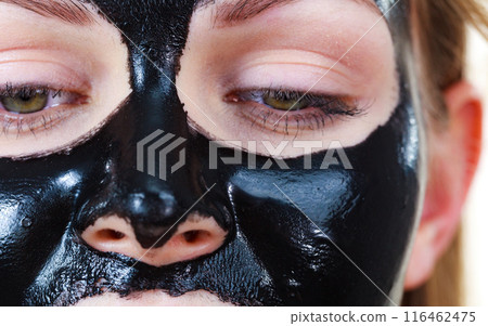 Girl black carbo peel off mask on face 116462475