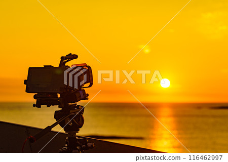 Camera take photo at sunset over sea Camera take photo at sunset over sea 116462997