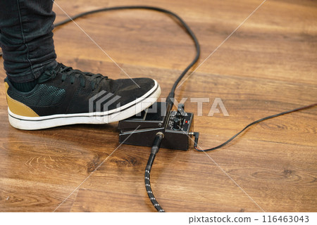 Man using guitar effects pedal Man using guitar effects pedal 116463043