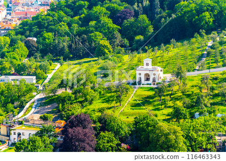 A view of Schnborn Garden with the Petrin Gardens, showcasing vibrant greenery and a classical pavilion amidst the lush landscape of Prague in spring. Prague, Czechia 116463343