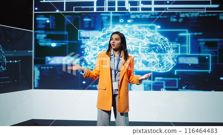 Lively speaker talks at AI event gathering tech startups managers, investors and academics. Expert hosts sessions geared towards helping IT business leaders tap into artificial intelligence, camera B 116464483