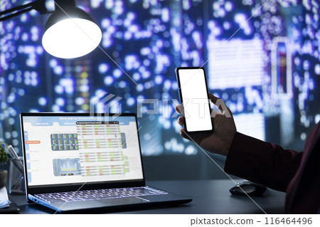Influential rich director using white display on smartphone, examining business transactions to manage financial resources. Billionaire holding phone with blank copyspace screen, time zones. Influential rich director using white display on smartphone, examining business transactions to manage financial resources. Billionaire holding phone with blank copyspace screen, time zones. 116464496