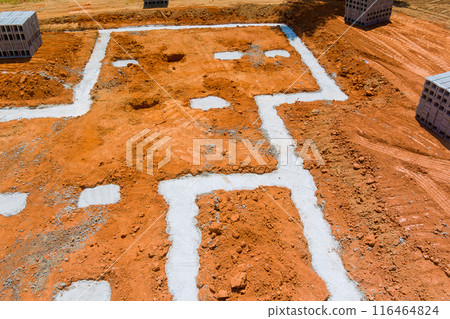 Concrete blocks delivered to construction site with foundation is ready for mounting wall of cement blocks Concrete blocks delivered to construction site with foundation is ready for mounting wall of cement blocks 116464824