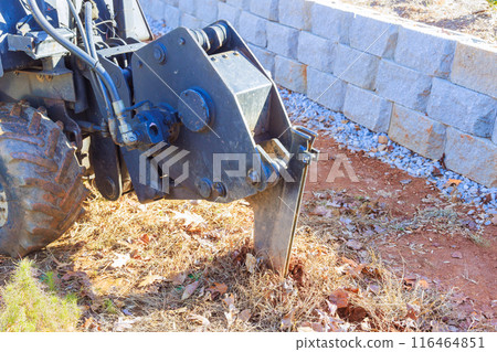 Laying fiber optic cables with the help of trencher cable plough tractor Laying fiber optic cables with the help of trencher cable plough tractor 116464851