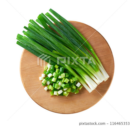 young green onions or scallions on a cutting board isolated on a white background. Top view. young green onions or scallions on a cutting board isolated on a white background. Top view. 116465353