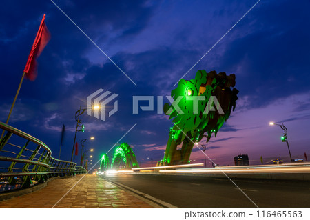 Motorcycles and cars running on the illuminated Dragon Bridge, a famous attraction in Da Nang, Vietnam Motorcycles and cars running on the illuminated Dragon Bridge, a famous attraction in Da Nang, Vietnam 116465563