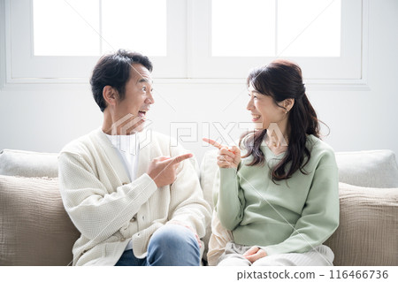 A middle-aged couple in the living room said, "That's it! I've decided!" 116466736