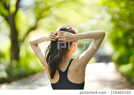 Young woman in sportswear jogging in the greenery Young woman in sportswear jogging in the greenery 116468160