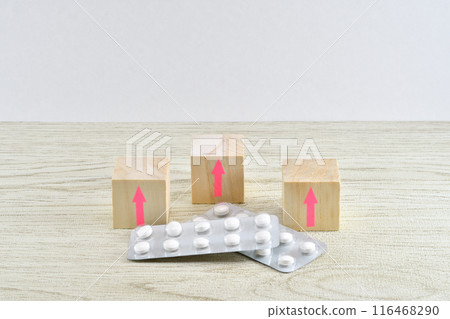 Medicines and arrows showing increase in copayment amount 116468290