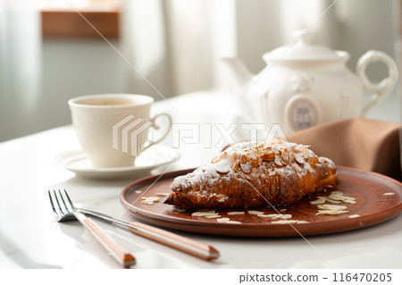 Almond Croissant on clay plate close up 116470205