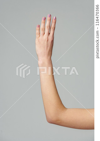 Female hand gesturing numbers on gray background 116470366