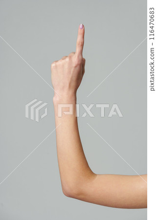 Female hand gesturing numbers on gray background Female hand gesturing numbers on gray background 116470683