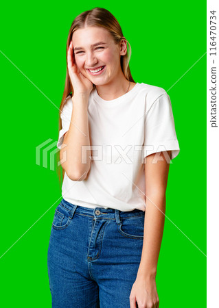 Young Woman Poses for Picture against green background. 116470734
