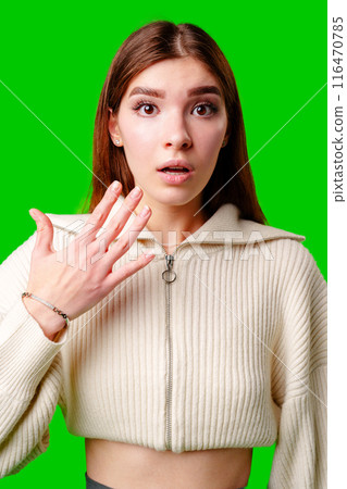 A woman wearing a white sweater is gesturing with her hand, possibly expressing emotion or emphasizing a point. A woman wearing a white sweater is gesturing with her hand, possibly expressing emotion or emphasizing a point. 116470785