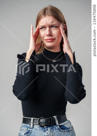 Young Woman In Black Shirt Expressing Discontent Against Grey Background Young Woman In Black Shirt Expressing Discontent Against Grey Background 116470806
