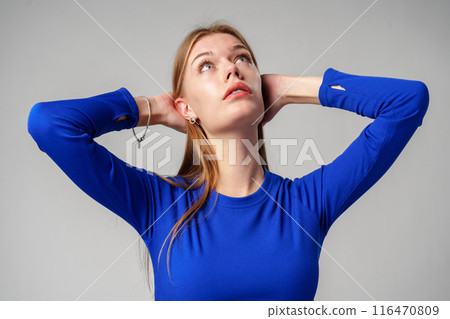 Portrait of Young Woman in Blue Top on gray background Portrait of Young Woman in Blue Top on gray background 116470809
