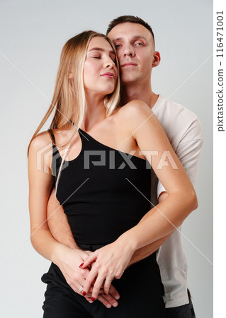 A Man and a Woman Standing Next to Each Other in studio A Man and a Woman Standing Next to Each Other in studio 116471001