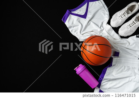 Basketball Gear Prepared for an Evening Training Session on a Dark Backdrop 116471015