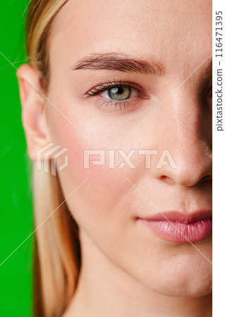 Close Up Portrait of Woman With Green Background Close Up Portrait of Woman With Green Background 116471395