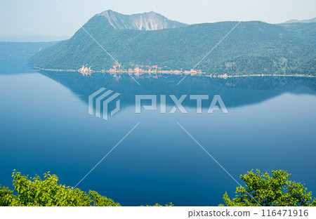 A view of Lake Mashu and Mount Mashu, with their beautiful blue surface, that I visited on a solo trip to Eastern Hokkaido. 116471916