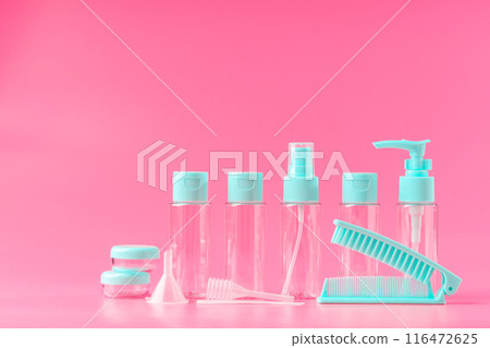 Five Empty Travel Bottles With Light Blue Caps on Pink Background Five Empty Travel Bottles With Light Blue Caps on Pink Background 116472625