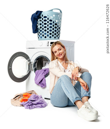 Woman Loading Clothes Into White Washing Machine on white background Woman Loading Clothes Into White Washing Machine on white background 116472626