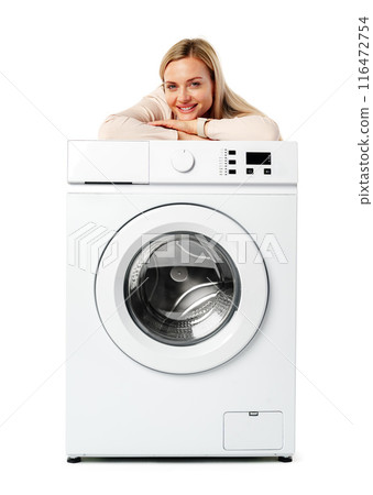 Young Woman Posing with White Washing Machine in a Studio Young Woman Posing with White Washing Machine in a Studio 116472754