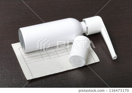 Inhaler for the treatment of respiratory organs. Spray can and cap white. Next recipe to buy. On a dark surface. Inhaler for the treatment of respiratory organs. Spray can and cap white. Next recipe to buy. On a dark surface. 116473170