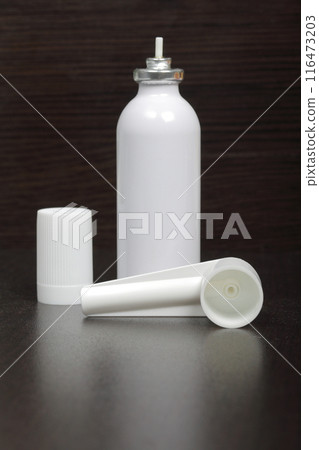 Inhaler for the treatment of respiratory organs. Spray can and cap white. On a dark surface. Inhaler for the treatment of respiratory organs. Spray can and cap white. On a dark surface. 116473203