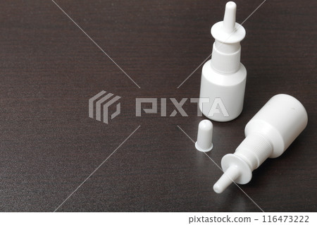 Nasal spray cans for the treatment of rhinitis. On a dark background. 116473222