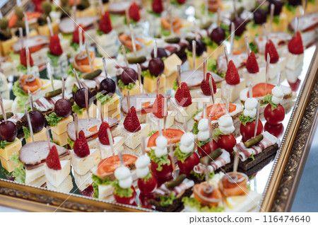 A large selection of various snacks for guests on a mirror surface. Buffet before an important event 116474640