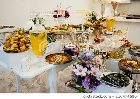 A wide variety of snacks on the table for guests. Shrimp, boiled pork, various types of meat and other products 116474690