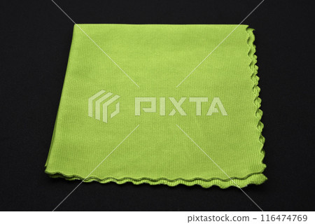 A green cleaning cloth on a black background. A green cleaning cloth on a black background. 116474769