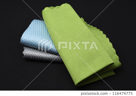 Colorful wiping cloths on a black background. A stack of rags. Cleaning material. 116474775