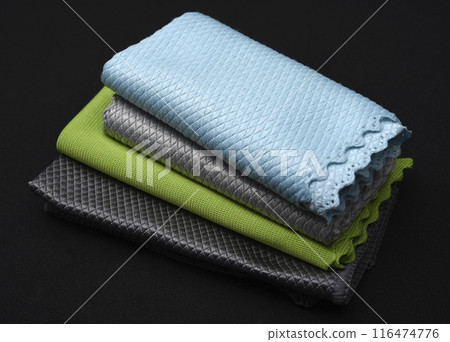 Colorful wiping cloths on a black background. A stack of rags. Cleaning material. 116474776