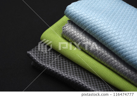 Colorful wiping cloths on a black background. A stack of rags. Cleaning material. 116474777