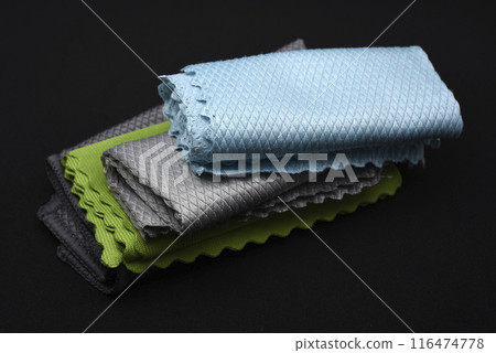 Colorful wiping cloths on a black background. A stack of rags. Cleaning material. 116474778