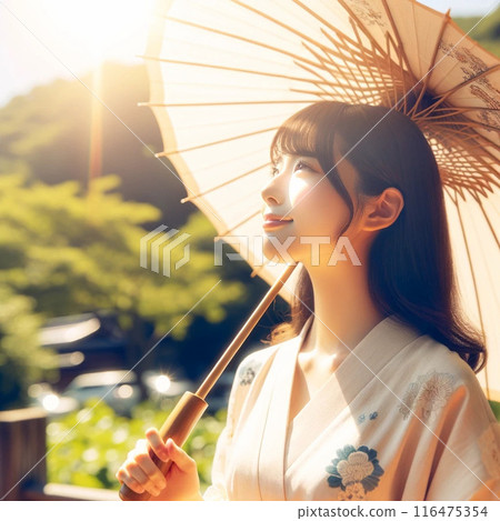 A woman wearing a yukata holding a Japanese umbrella 116475354