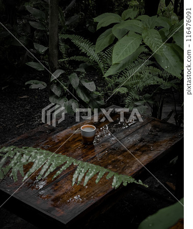 flower in a glass jar on a wooden table 116476091