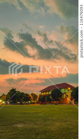 sunset over village 116476093