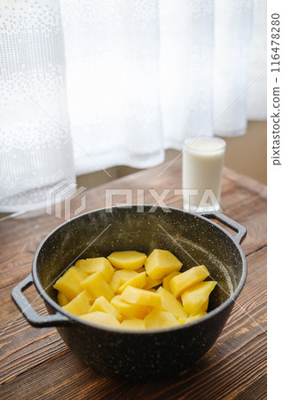 Kitchen table with boiled potatoes in a pot Kitchen table with boiled potatoes in a pot 116478280