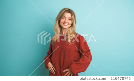 Happy woman laughing at camera in blue studio 116478745