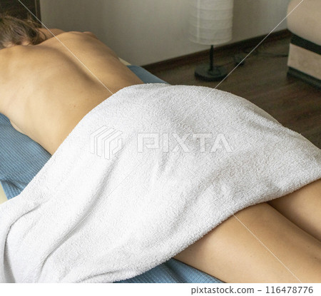 Shot of the young female relaxing after massage in the spa. 116478776