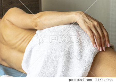 Shot of the young female relaxing after massage in the spa. 116478790