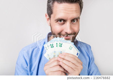 photo of positive man with earning money. man with earning money isolated on studio 116478882