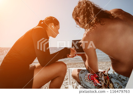 Man woman laptop sea. Working remotely on seashore. Happy successful couple, freelancers working on sea beach, relieves stress from work to restore life balance. Freelance, remote work on vacation Man woman laptop sea. Working remotely on seashore. Happy successful couple, freelancers working on sea beach, relieves stress from work to restore life balance. Freelance, remote work on vacation 116479763