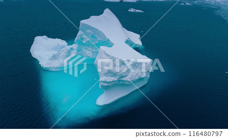 Antarctica melting blue iceberg drifting ocean water. Glacier arch hole in melted ice. Environment ecological issue of global warming, climate change. Cinematic aerial drone panorama Antarctica melting blue iceberg drifting ocean water. Glacier arch hole in melted ice. Environment ecological issue of global warming, climate change. Cinematic aerial drone panorama 116480797