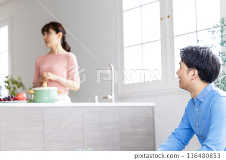 A wife who ignores her husband who is talking to her A wife who ignores her husband who is talking to her 116480853