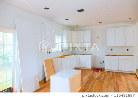 During construction of new house, custom kitchen cabinets are installed in kitchen 116481697